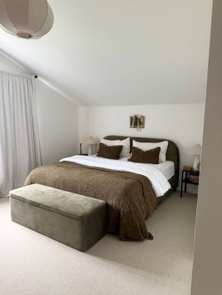 cream bedroom carpet with a khaki green velvet double bed